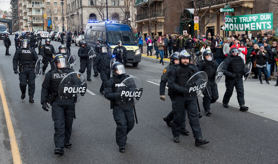 (Rick Egan  |  The Salt Lake Tribune)  Police attempt to disperse protesters as they block traffic on State Street, during President Trump's visit to Salt Lake City, Monday, December 4, 2017.