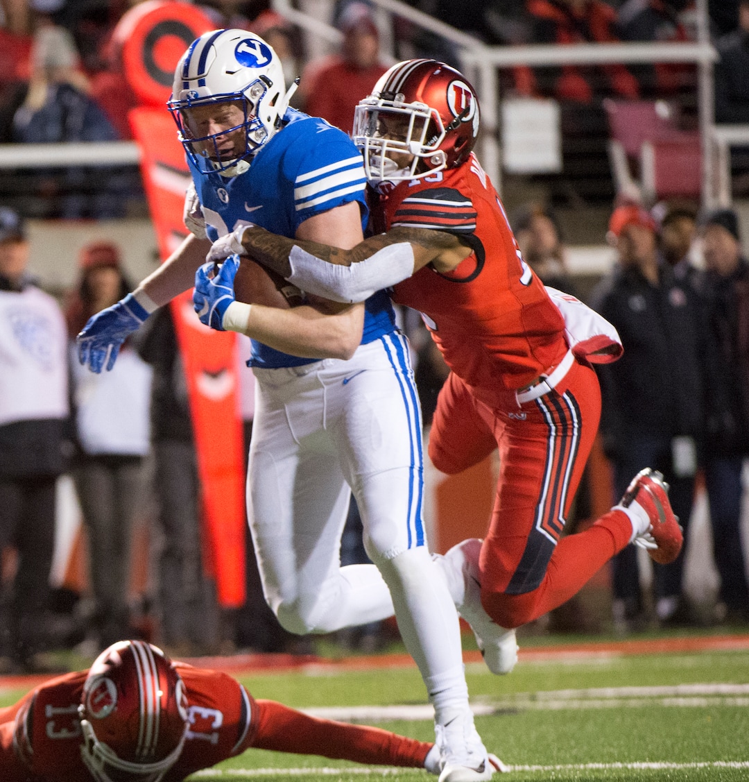 (Rick Egan  |  The Salt Lake Tribune)      Brigham Young Cougars tight end Matt Bushman (89) gets past Utah defensive back Marquise Blair (13) and Utes defensive back Corrion Ballard (15) to score a touchdown for the Cougars, in football action between the Brigham Young Cougars and the Utah Utes, at Rice-Eccles Stadium, Saturday, November 24, 2018.