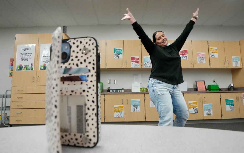 (Francisco Kjolseth | The Salt Lake Tribune) Kati Jo Christensen, a special education teacher for elementary students in the Weber County district, uses her phone to record a dance to music on Wednesday, March 5, 2025. Kati got creative to help alleviate the student lunch deficit by creating a daily dance video on TikTok (MrsCactusVibes), to raise money to pay off student lunch deficits, raising over $11,000 so far.