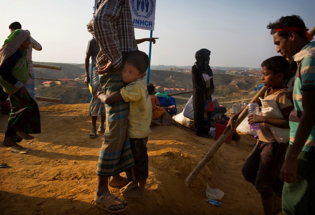 A Rohingya refugee boy who was staying in no-man's land at Bandarban between Myanmar and Bangladesh border, clings to his father after arriving at Balukhali refugee camp 50 kilometres (32 miles) from, Cox's Bazar, Bangladesh Wednesday, Jan. 24, 2018. Rohingya Muslims who fled persecution in Myanmar say some of them had returned home several times over past decades, and they're in no mood to repatriate again. Although, Myanmar says it's ready for a gradual repatriation of Muslim Rohingya refugees chased out by the Buddhist-majority country's military. More than 680,000 Rohingya Muslims are now living in sprawling and squalid refugee camps in Bangladesh. (AP Photo/Manish Swarup)