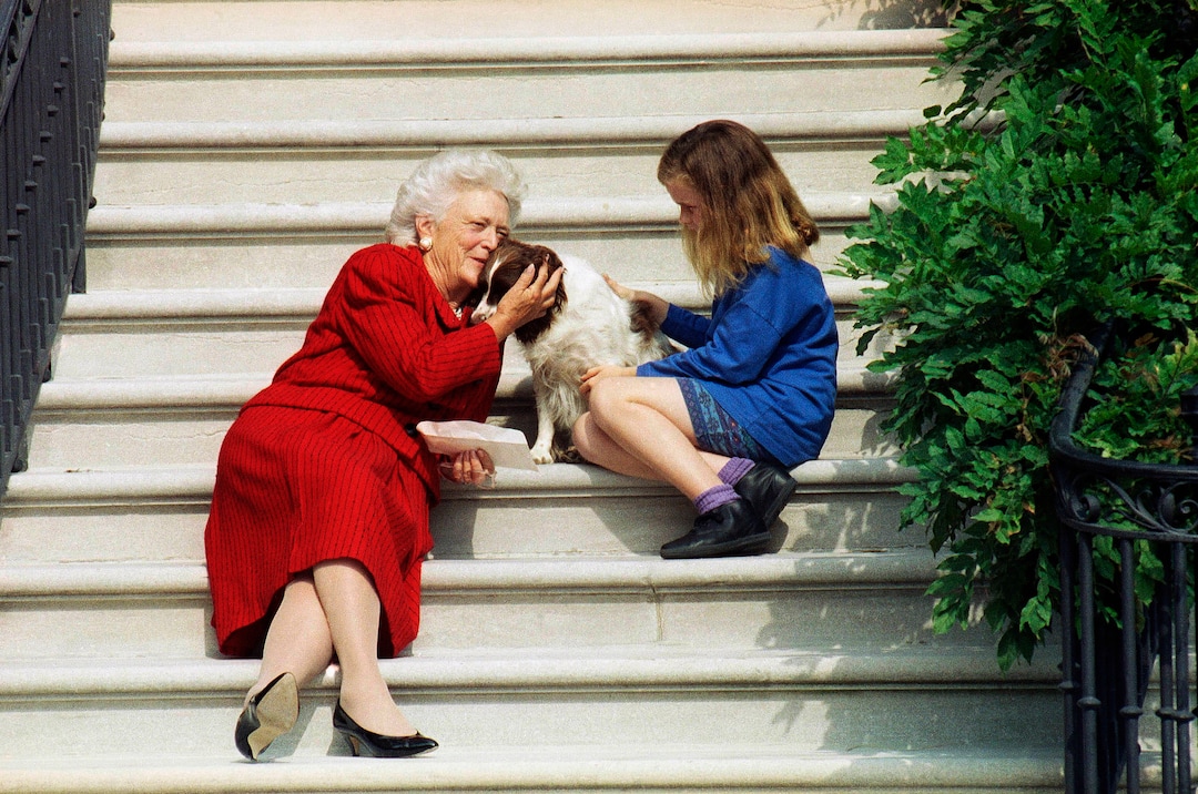 FILE - In this Sept. 13, 1991, file photo, first lady Barbara Bush, her granddaughter Barbara, and Millie wait on the steps of the White House for U.S. President George H.W. Bush to return from his check-up at Bethesda Naval Hospital in Washington. A family spokesman said Tuesday, April 17, 2018, that former first lady Barbara Bush has died at the age of 92. (AP Photo/Barry Thumma, File )