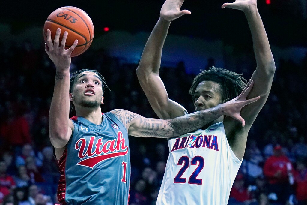Utah forward Timmy Allen (1) shields the ball from Arizona forward Zeke Nnaji during the first half of an NCAA college basketball game Thursday, Jan. 16, 2020, in Tucson, Ariz. (AP Photo/Rick Scuteri)