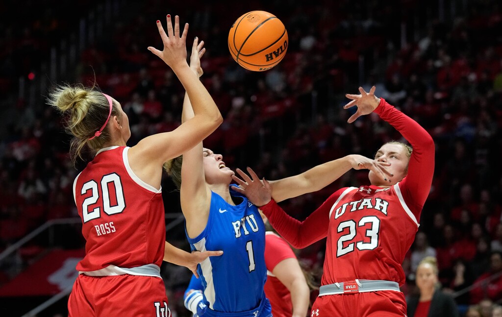 (Francisco Kjolseth | The Salt Lake Tribune) Utah Utes forward Reese Ross (20) and Utah Utes guard Matyson Wilke (23) crowd BYU Cougars guard Amari Whiting (1) on her way to the basket as Utah hosts BYU in NCAA basketball at the Huntsman Center in Salt Lake City on Saturday, Dec. 2, 2023.