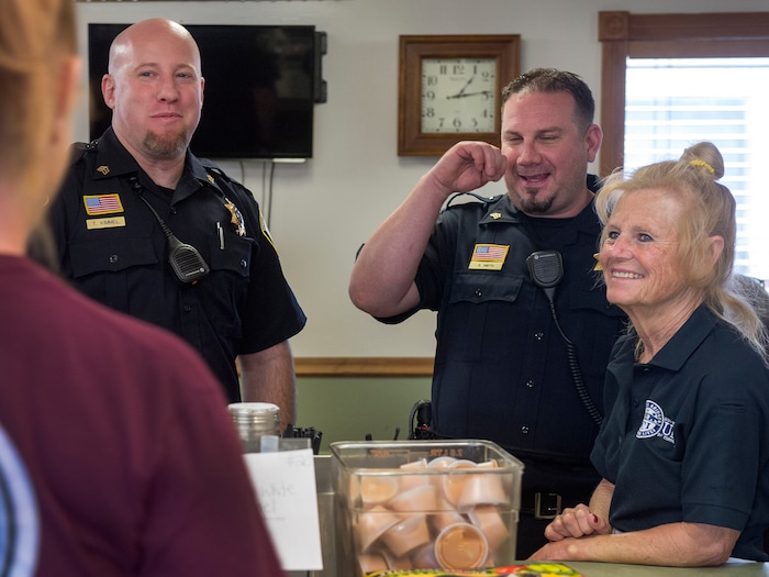 (Leah Hogsten  |  The Salt Lake Tribune) l-r Department of Corrections officers Sgt. Trevor Kimmel and Sgt. Brian Smith joke with cafe manager Carolyn Price and her students, many of whom they supervise on the inside of the women's facility. Every Monday through Friday, a half-dozen or so Level 4 inmates file out of the Olympus Facility at the Utah State Prison to cook, bake and serve the public at the Serving Time Caf. The operation is part of Utah Department of Corrections Industries (UCI) and is aimed at helping inmates return to society.