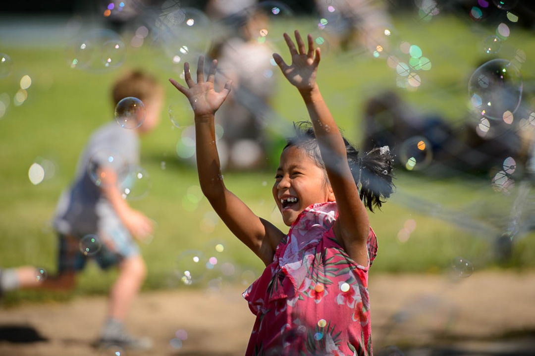 (Trent Nelson | The Salt Lake Tribune)Children play in a swarm of bubbles created by Arnold Berg of Monster Bubbles at the opening day of the 2018 Downtown Farmers Market at Pioneer Park in Salt Lake City, Saturday June 9, 2018. In pink is Brayana Sky.