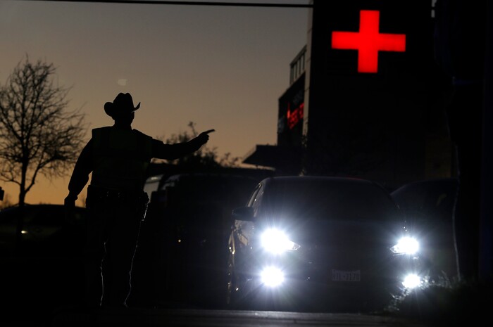 Texas troopers help redirect traffic near the site of another explosion, Tuesday, March 20, 2018, in Austin, Texas. Emergency teams were responding  to another reported explosion in Texas' capital, this one at a Goodwill store in the southern part of the city. (Jan Janner/Austin American-Statesman via AP)