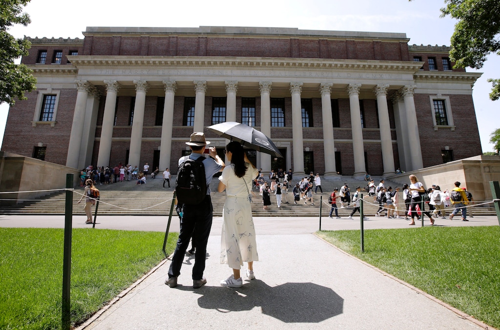 (Steven Senne | AP file photo) People stop to record images of Widener Library on the campus of Harvard University in Cambridge, Mass., July 16, 2019. U.S. District Judge Allison D. Burroughs ruled, Tuesday, Oct. 1, 2019, that Harvard does not discriminate against Asian Americans in its admissions process. The judge issued the ruling in a 2014 lawsuit that alleged Harvard holds Asian American applicants to a higher standard than students of other races. Burroughs said Harvard's admissions process is not perfect but passes constitutional muster.