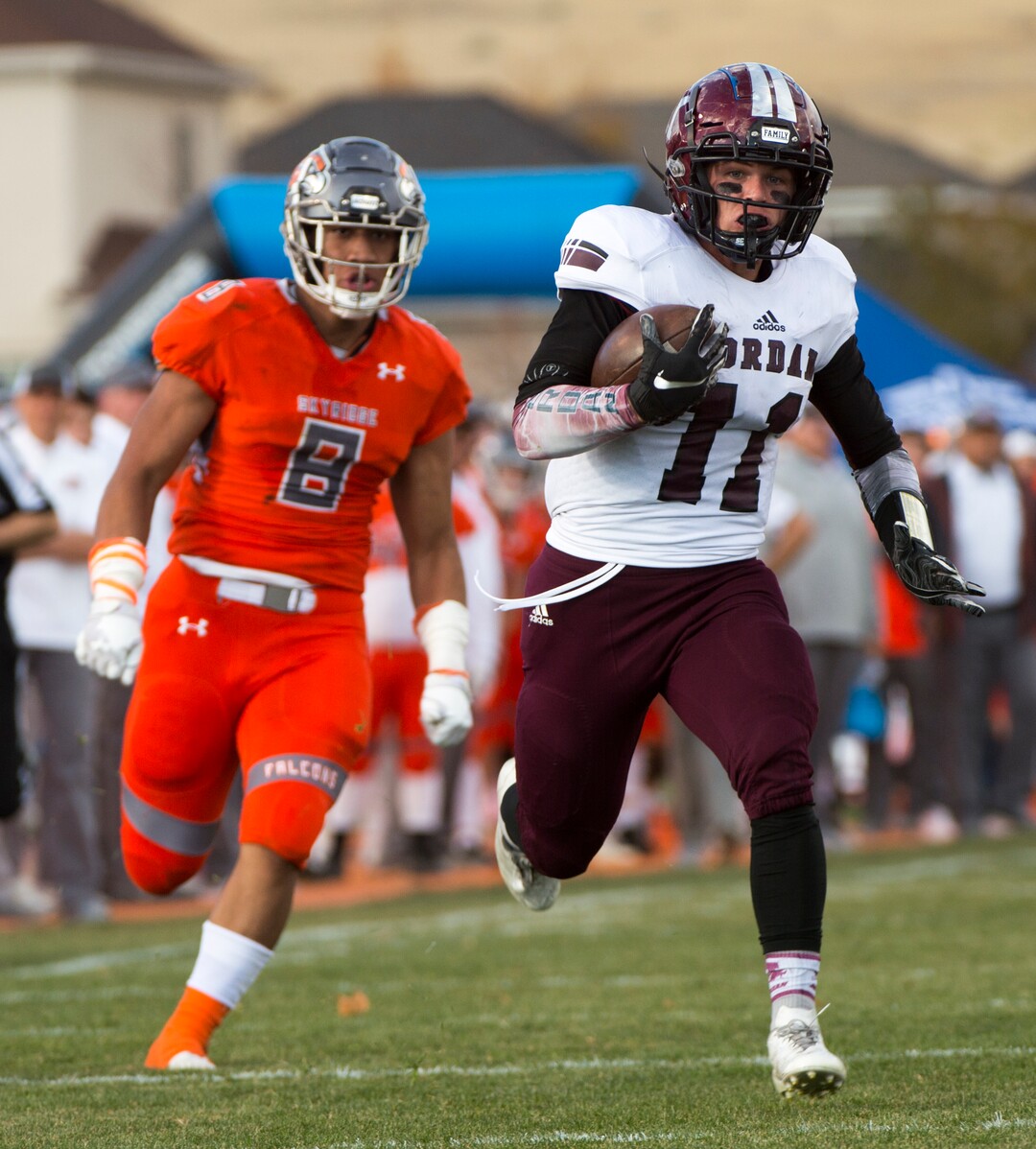 (Rick Egan  |  The Salt Lake Tribune)   Jordan running back Jake Shaver (11) runs for a touchdown, in prep 5A playoff action between Jordan High and Skyridge High, in Lehi, Friday, Nov. 2, 2018.