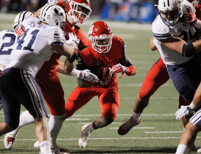 Fresno State's running back Jordan Mims runs through the line as BYU's Adam Pulsipher (41) tries to stop him during the second half of an NCAA college football game in Fresno, Calif., Saturday, Nov. 4, 2017. Fresno State won the game 20-13. (AP Photo/Gary Kazanjian)