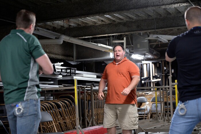 (Al Hartmann | The Salt Lake Tribune)
Dax Shane, a detective assigned to domestic violence with Salt Lake City Police, center, play acts a violent and possibly suicidal man who thinks he is dying of AIDS in a scenario to train new police academy recruits. SLCPD recruits Jeremy Dimand, left, and Joel Morgan, right, had to draw guns because Shane is confrontational, violent and pulled a large knife threatening to kill himself. A difficult situation taken from real life. The recruits had to de-escalate the situation, calm the person down while still protecting themselves. The Salt Lake City Police Department hosted a Crisis Intervention Team (CIT) Academy for police officers and police trainees Thursday, May 10, 2018. The academy provides training for officers and recruits to learn about and identify signs of citizens who are experiencing a mental health crisis.