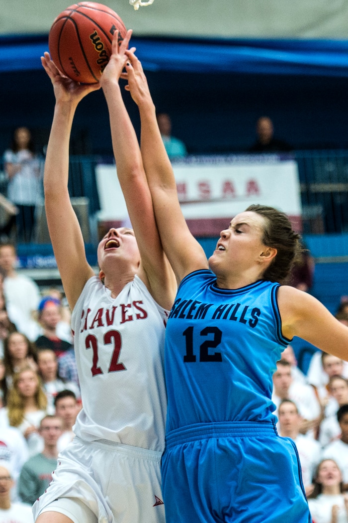 Chris Detrick  |  The Salt Lake TribuneSalem Hills's Lauren Gustin (12) fouls Bountiful's Mary Larson (22) during the 4A girls' basketball semifinals at Salt Lake Community College Friday February 26, 2016. Bountiful won the game 59-51.