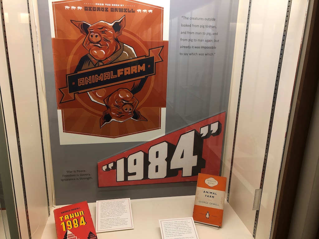 In this Oct. 21, 2019, photo, a poster promoting George Orwell's novels "Animal Farm" and "1984" is shown at an exhibit in Albuquerque, N.M. celebrating the author's legacy. (AP Photo/ Russell Contreras)