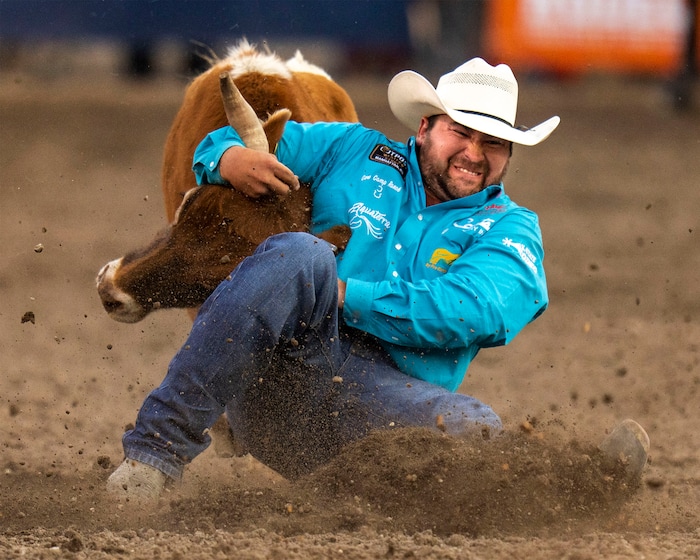 (Rick Egan | The Salt Lake Tribune)  Tanner Brunner, from Ramona, Kansas, competes in the steer wrestling competition at the Utah Days of '47 Rodeo at the State Fairpark, on Monday, July 25, 2022.