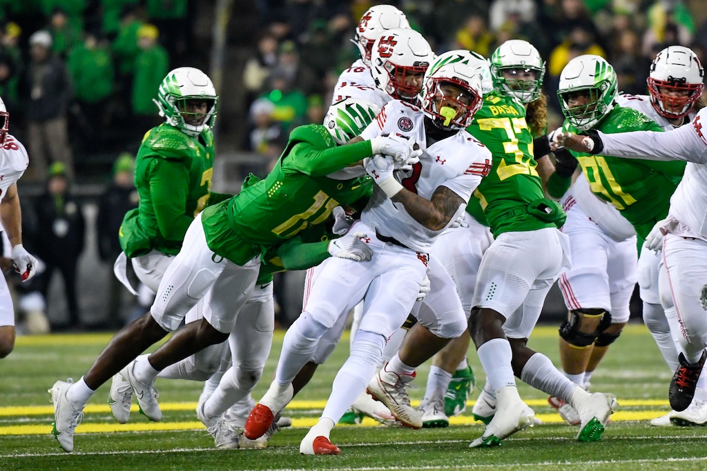 (Andy Nelson | AP) Utah running back Ja'Quinden Jackson is tackled by Oregon defensive back Trikweze Bridges (11) during the first half of an NCAA college football game Saturday, Nov. 19, 2022, in Eugene, Ore.