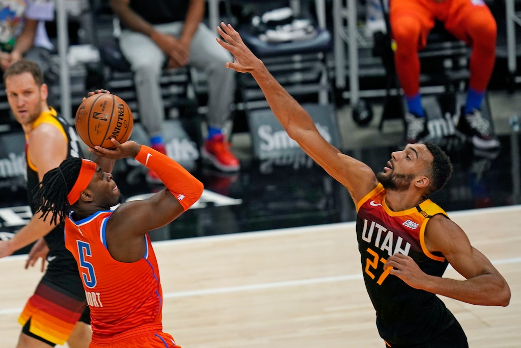 Oklahoma City Thunder forward Luguentz Dort (5) shoots as Utah Jazz center Rudy Gobert (27) defends during the first half of an NBA basketball game Tuesday, April 13, 2021, in Salt Lake City. (AP Photo/Rick Bowmer)