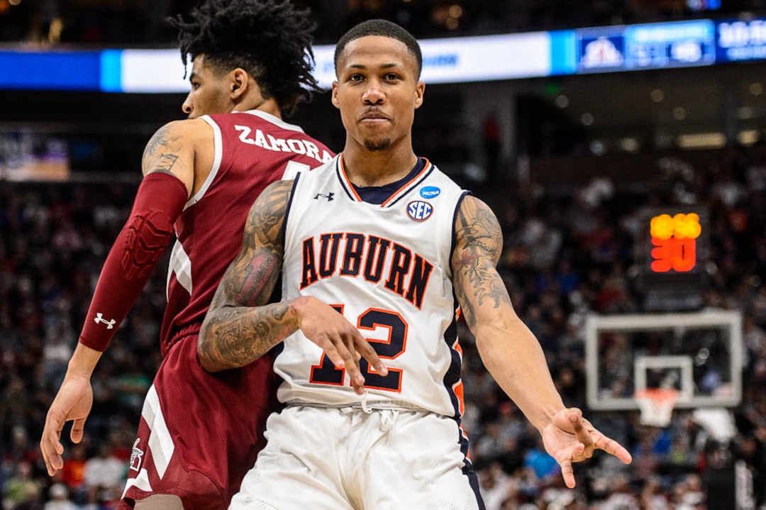 (Trent Nelson | The Salt Lake Tribune)  Auburn Tigers guard J'Von McCormick (12) plays air guitar to celebrate a basket as Auburn faces New Mexico State in the 2019 NCAA Tournament in Salt Lake City on Thursday March 21, 2019.
