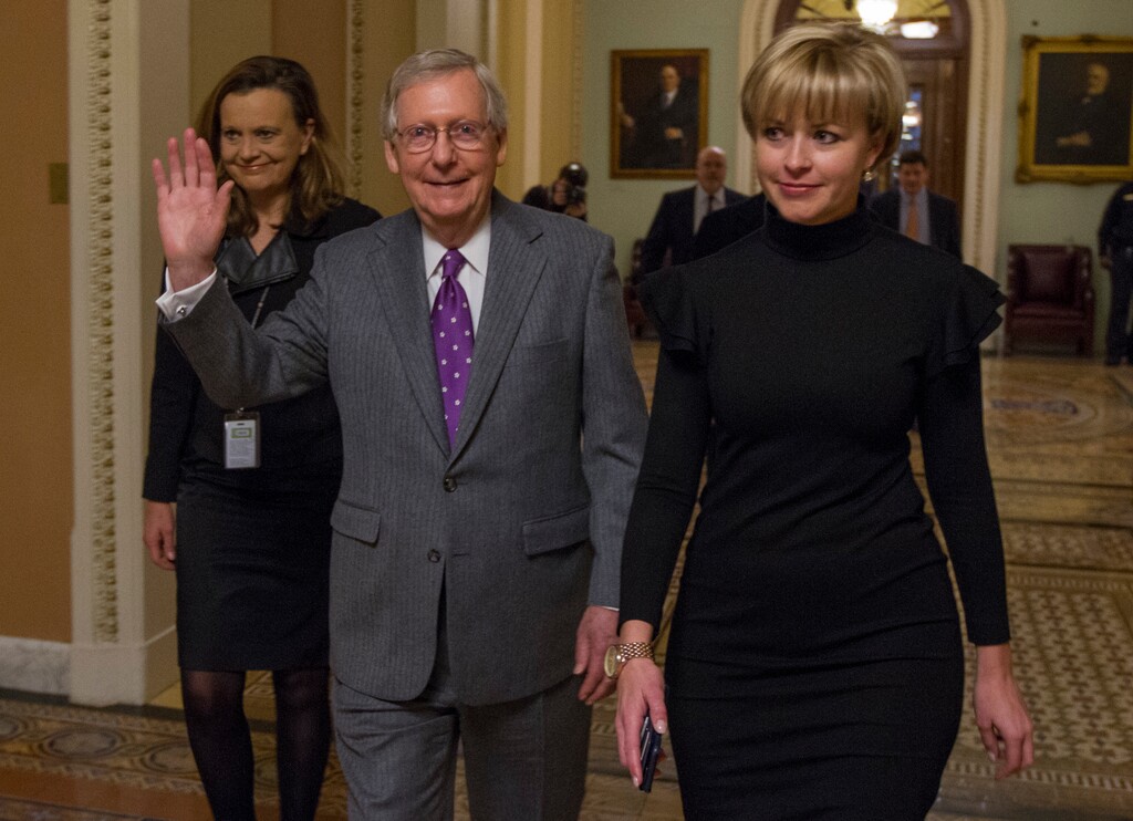 Senate Majority Leader Mitch McConnell of Ky., waves as he leaves the Senate chamber early Friday, Feb. 9, 2018, on Capitol Hill in Washington, after the Senate passed a budget deal and spending measure to reopen the federal government, sending the bill to the House. (AP Photo/Jon Elswick)