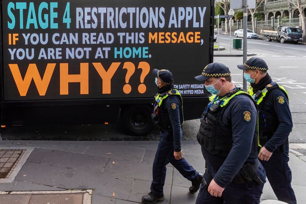 (Asanka Brendon Ratnayake | AP photo)
Victorian protective service officers are seen walking on patrol past a sign to urge people to stay home as lockdown of Melbourne forces people to stay at home if not working due to the continuing spread of COVID-19, Wednesday. Victoria state, Australia's coronavirus hot spot, announced on Monday that businesses will be closed and scaled down in a bid to curb the spread of the virus.