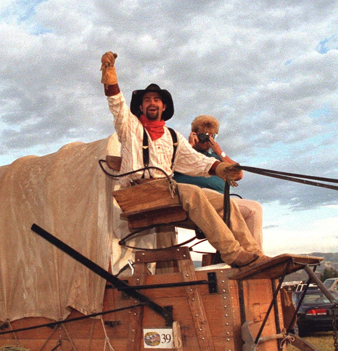 Rick Egan  | Tribune File Photo Larry Turbo Wayne Stewart waves to the crowd along the trail in Utah. 