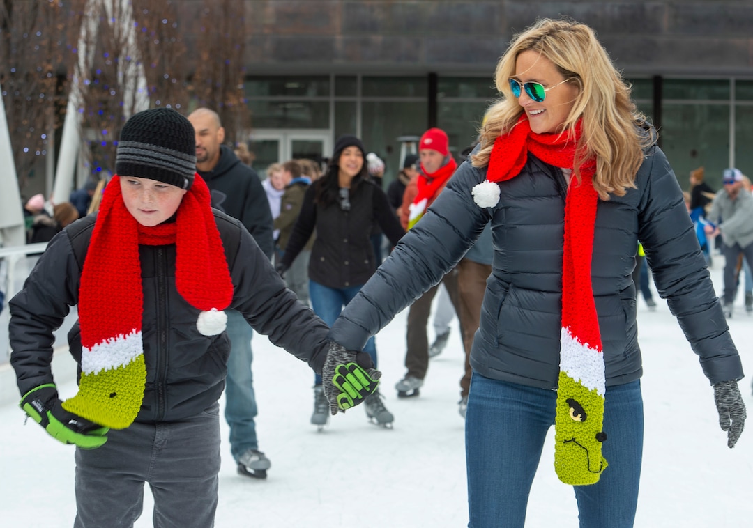(Rick Egan  |  The Salt Lake Tribune) Quinn Nikkel, 10, skates with his mother, Tiffany Nikkel, from San Diego, while wearing their family grinch scarves at the Gallivan Center ice rink on Christmas Eve, Tuesday, Dec. 24, 2019. Tiffany and her family have been ice skating on Christmas Eve for the past 35 years.