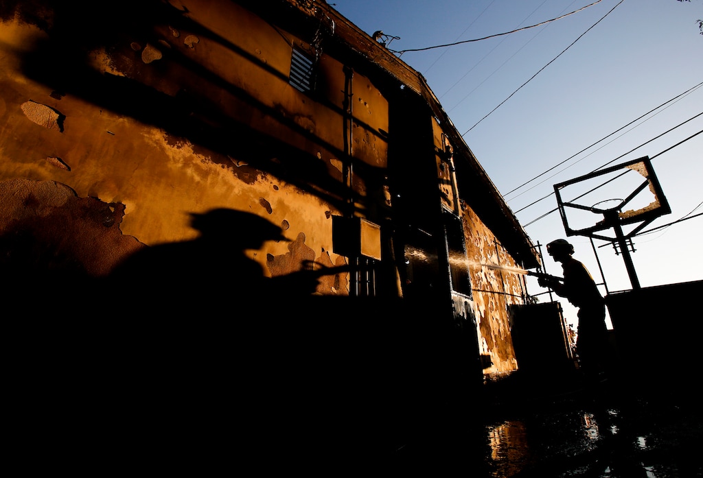 (Ringo H.W. Chiu | AP) A firefighter works on a house destroyed by a wildfire called the Getty Fire in Los Angeles, Monday, Oct. 28, 2019.