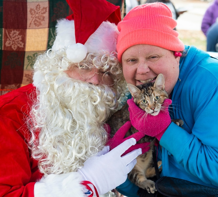 (Rick Egan  |  The Salt Lake Tribune)    Becki Butts and her cat Charme, posse for photo with Santa, at the Street Dawg Crew Christmas outreach at Liberty Park Sunday.  The Street Dawg Crew supports the homeless and their pets every Sunday at Pioneer Park.  For today's Christmas Outreach, the Street Dawg Crew passed out food and gift bags for humans and animals, and also offered a photo opportunity with Santa. Sunday, Dec. 22, 2019.