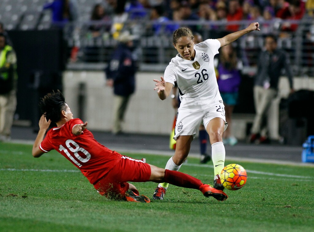 FILE - In this Dec. 13, 2015, file photo, China's Han Peng (18) slides in to knock the ball away from United States' Jaelene Hinkle during the second half of an international friendly soccer match, in Glendale, Ariz. Hinkle revealed she decided not to play for the U.S. women's national team last year because her Christian faith prevented her from wearing a jersey that commemorated LGBTQ Pride Month. Hinkle revealed the reason for her decision last June in an interview posted Wednesday, May 30, 2018, on The 700 Club website. (AP Photo/Ralph Freso, File)