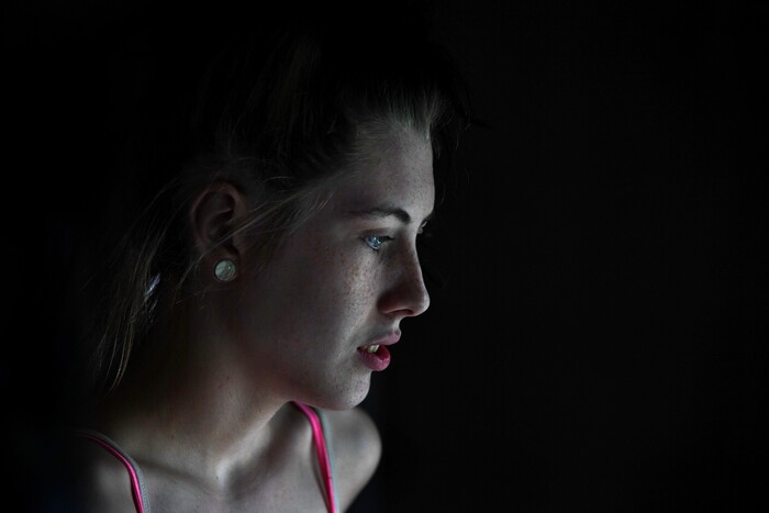 (Washington Post photo by Michael S. Williamson) Maria, 16, glances out the window of her mobile home to watch her husband Phil mow the lawn.