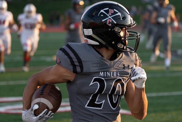 (Francisco Kjolseth | The Salt Lake Tribune) Jack Mchenry (20) puts down some yardage to score the first touchdown for Park City in the first few minutes of the game In prep football action between Park City Miners and the East Leopards on Friday, Sept. 3, 2021.