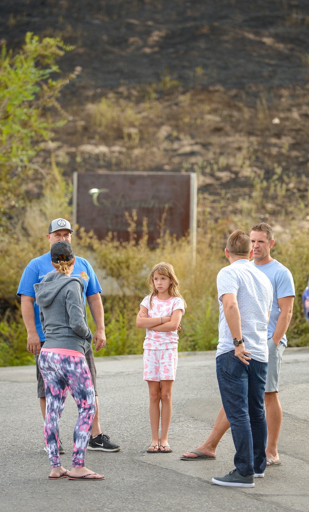 Leah Hogsten  |  The Salt Lake Tribune  l-r  Columbus Court residents Jenna Holt, Dave Hart, Madison Hart, 9, Justin Peterson and Dustin Holt talk about their roles in trying to hold of Tuesday's grass fire in their neighborhood. Five people were injured and one home was damaged by a fast-moving grass fire on Columbus Court, Tuesday, July 24, 2018. Forty homes were evacuated as flames spread through about 100 acres. Between 50 and 60 firefighters responded to the fire.