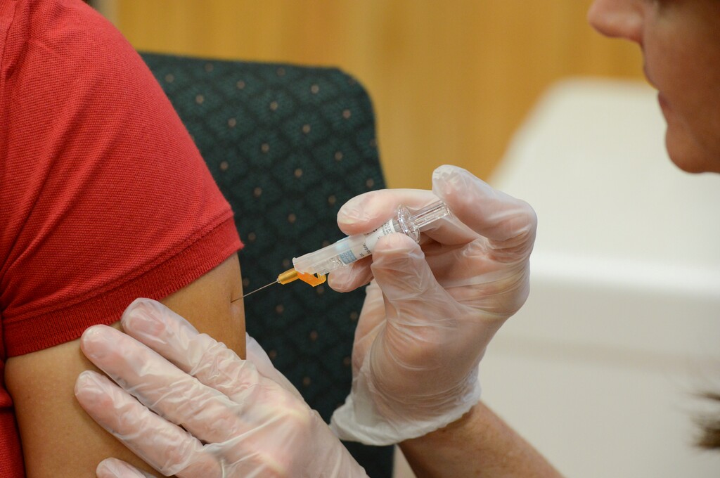 (Jason Hoekema/The Brownsville Herald via AP) In this Friday, Sept. 16, 2016 file photo, a woman receives a flu vaccine shot at a community fair in Brownsville, Texas.