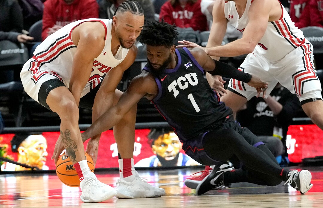 (Leah Hogsten | The Salt Lake Tribune) Utah Utes guard Marco Anthony (10) and TCU Horned Frogs guard Mike Miles Jr. (1) battle for a loose ball as the University of Utah hosts the TCU Horned Frogs at Vivint Arena, Dec. 21, 2022. 