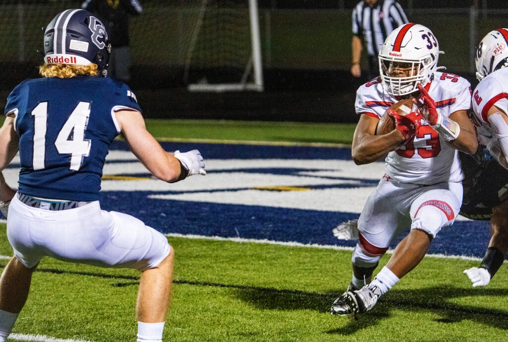 (Rick Egan | The Salt Lake Tribune)  Jon King (14) defends for the chargers, as Omar Shah runs the ball after intercepting a pass in the end zone for East High, in prep football action between Corner Canyon Chargers and the East Leopards, on Saturday. East has canceled its game this week against Lone Peak due to COVID-19 concerns.