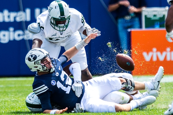 (Chris Detrick  |  The Salt Lake Tribune)  Portland State Vikings defensive end Davond Dade (99) sacks Brigham Young Cougars quarterback Tanner Mangum (12) during the game at LaVell Edwards Stadium Saturday, August 26, 2017.