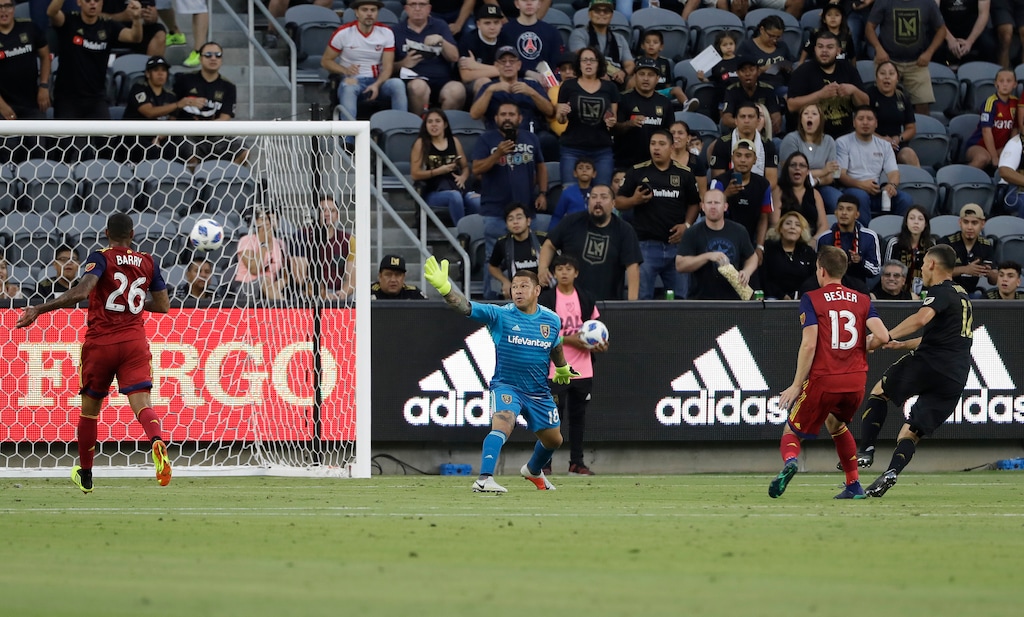 Real Salt Lake goalkeeper Nick Rimando, center, gives up a goal on a head ball by Los Angeles FC's Christian Ramirez, right, during the first half of an MLS soccer match Wednesday, Aug. 15, 2018, in Los Angeles. (AP Photo/Marcio Jose Sanchez)