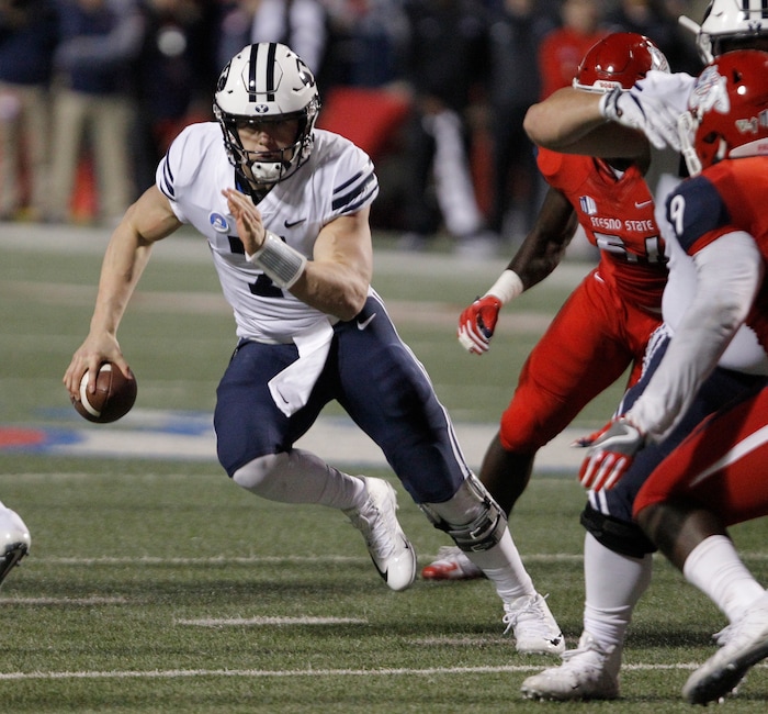 BYU's quaterback Beau Hoge tries to avoid Fresno State defenders during the first half of an NCAA college football game in Fresno, Calif., Saturday, Nov. 4, 2017. (AP Photo/Gary Kazanjian)