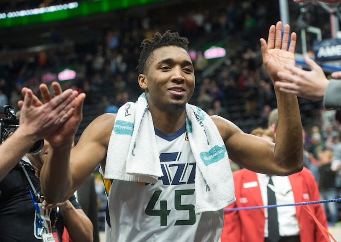 (Rick Egan  |  The Salt Lake Tribune)  Utah Jazz guard Donovan Mitchell (45) is all smiles as he heads to the locker room after the Jazz defeated the Spurs 101-99, in NBA action in Salt Lake City, Monday, February 12, 2018.