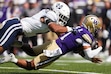 Utah State linebacker Asher Cunningham tackles Washington quarterback Demond Williams Jr., right, during the first half of an NCAA college football game Saturday, Sept. 12, 2026, in Seattle. (AP Photo/Lindsey Wasson)
