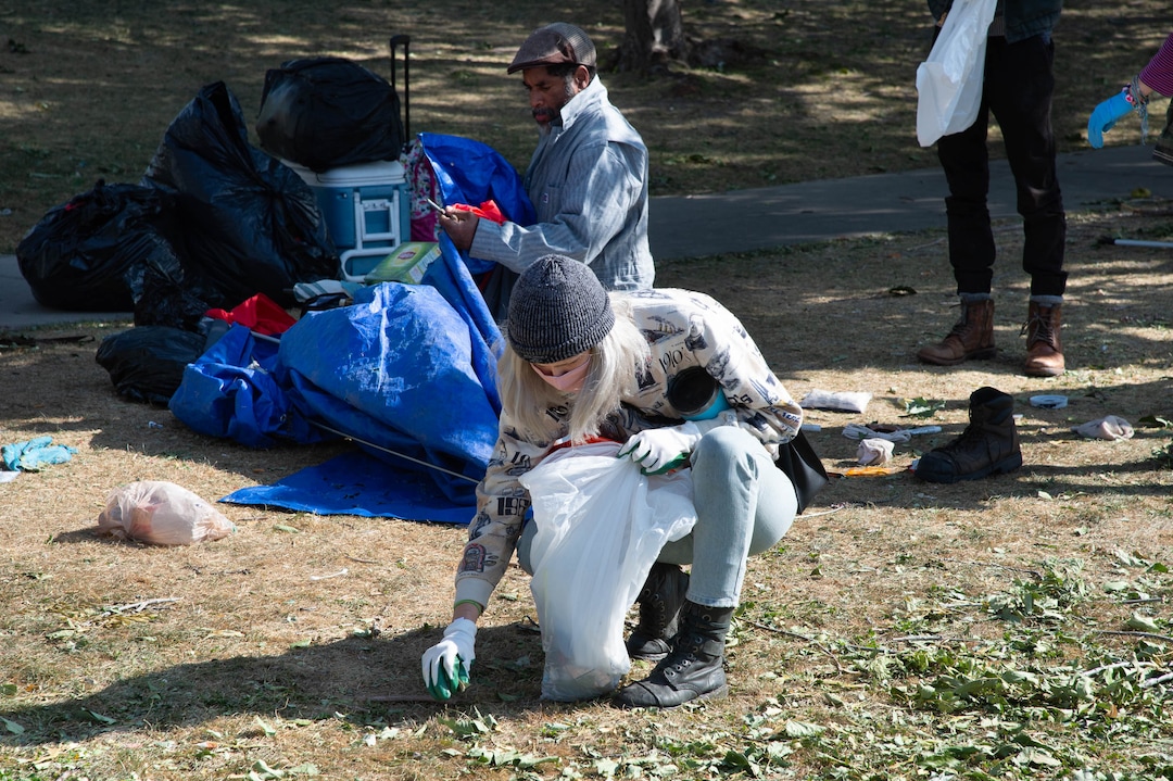 (Francisco Kjolseth  |  The Salt Lake Tribune) Homeless advocate volunteers lend their support by cleaning up trash as the Salt Lake County Health Department, backed by police, force a clean up of homeless camps near Taufer Park in Salt Lake City on Thursday, Sept. 10, 2020.