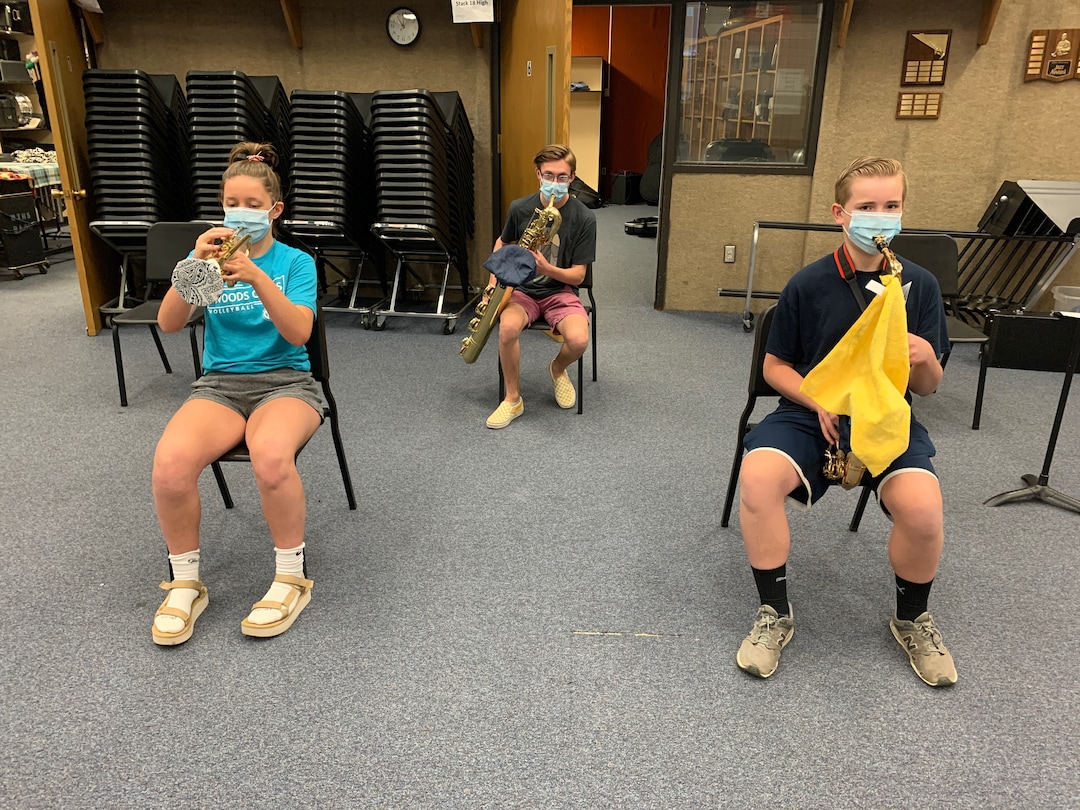 (Photo courtesy of Todd Campbell) Woods Cross High School band students practice on covered wind and brass instruments while wearing masks.