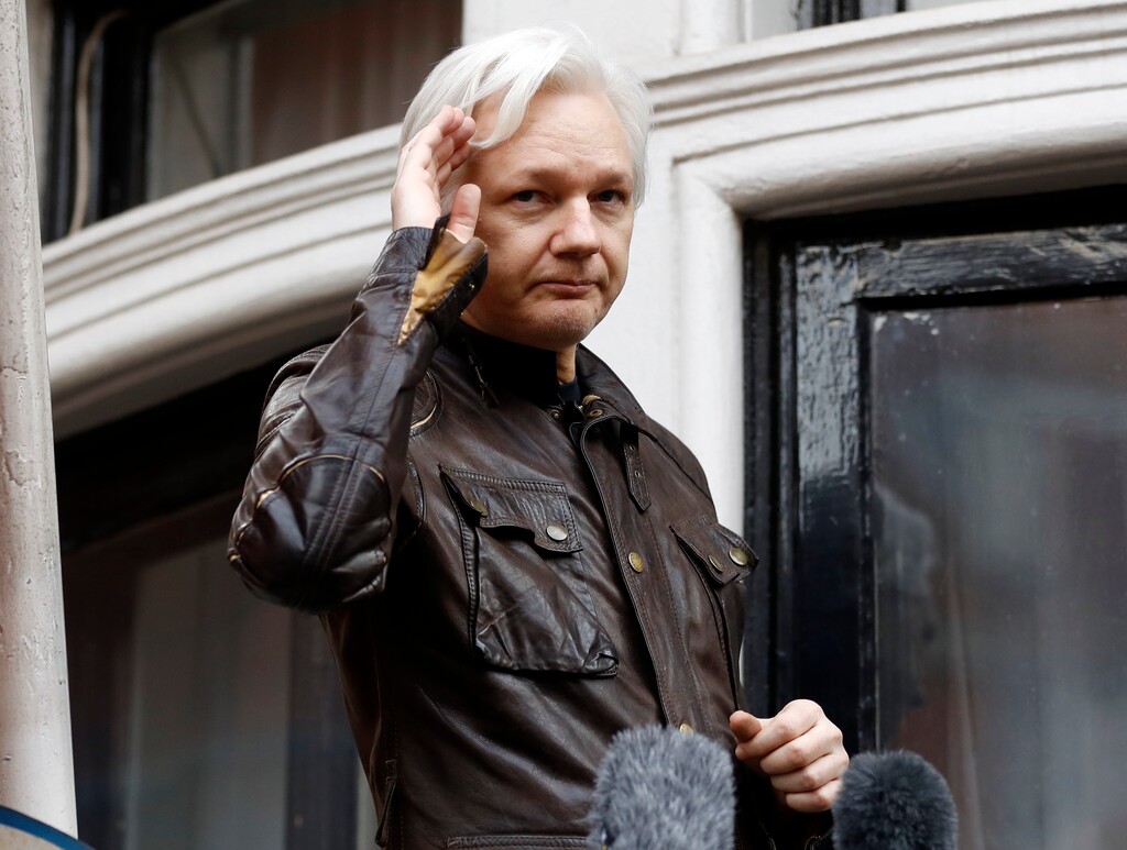 (Frank Augstein | The Associated Press) In this May 19, 2017 file photo, WikiLeaks founder Julian Assange greets supporters from a balcony of the Ecuadorian embassy in London. The Justice Department's indictment Friday, July 13, 2018 of 12 Russian military intelligence officers for U.S. election hacking undermine denials by WikiLeaks founder Julian Assange that the Russian government was the source of stolen Democratic Party emails published by the anti-secrecy organization.