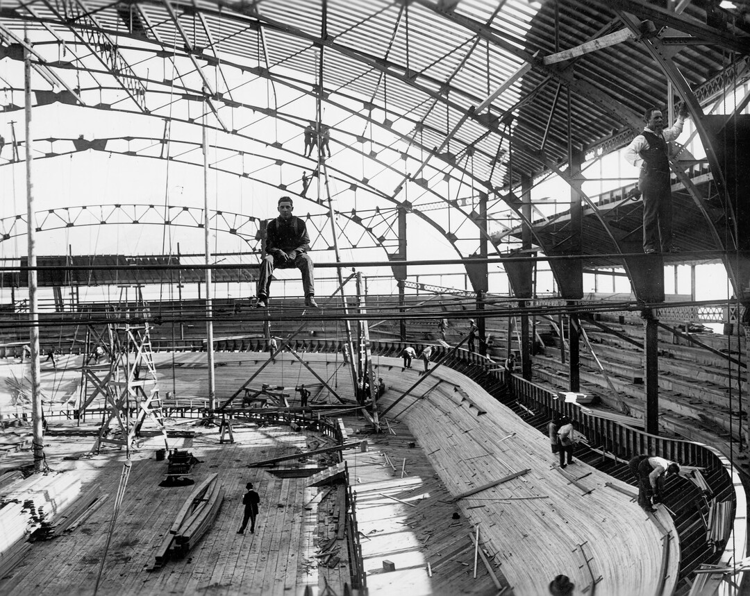 (Utah State Historical Society) A man sits on scaffolding at the Saltair Coliseum, which was under construction, June 15, 1908. The coliseum featured a banked velodrome track for competitive bicycle races. 