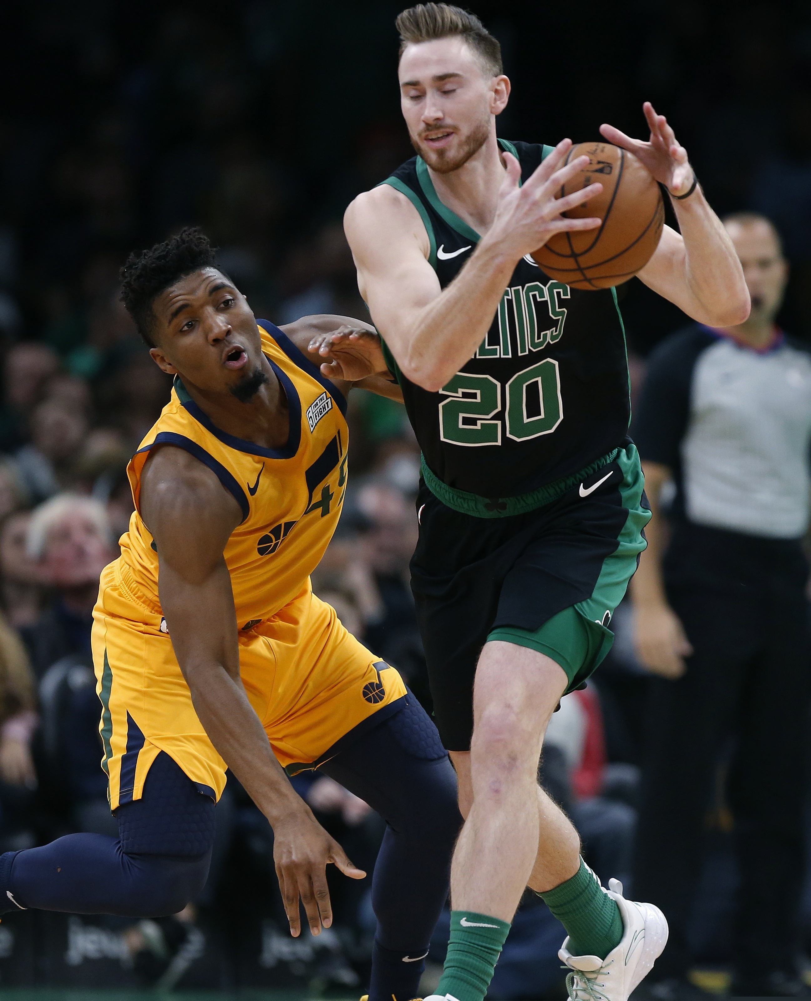 Boston Celtics' Gordon Hayward (20) and Utah Jazz's Donovan Mitchell (45) battle for the  e ball during the first half on an NBA basketball game in Boston, Saturday, Nov. 17, 2018. (AP Photo/Michael Dwyer)