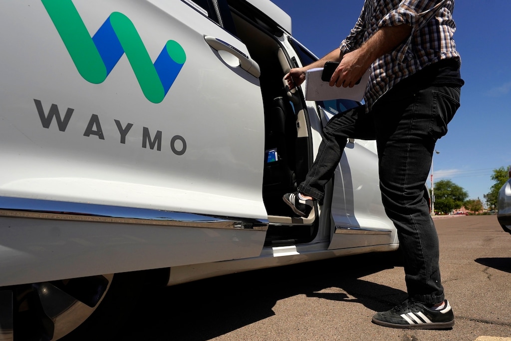 A Waymo minivan arrives to pick up passengers for an autonomous vehicle ride, Wednesday, April 7, 2021, in Mesa, Ariz.  (AP Photo/Ross D. Franklin)