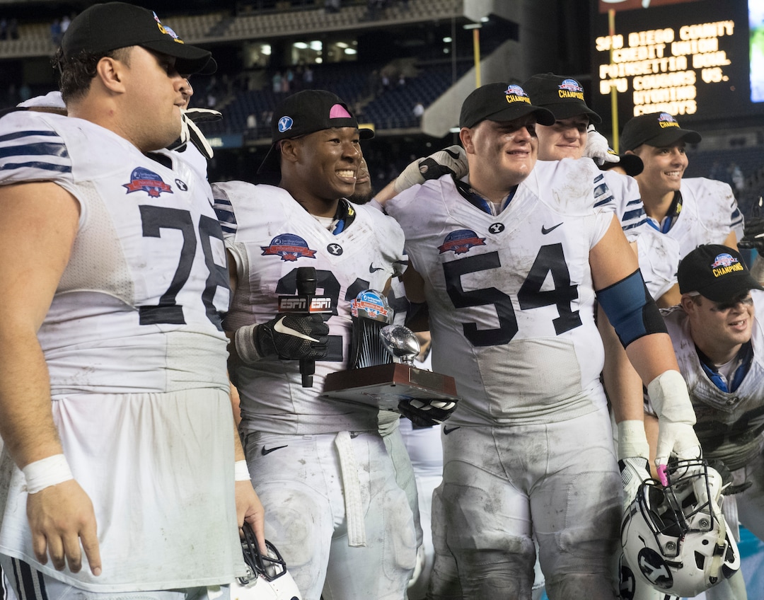 Rick Egan  |  The Salt Lake TribuneBrigham Young Cougars running back Jamaal Williams (21) stands with offensive lineman, Tuni Kanuch (78), and Parker Dawe (54) after he was presented the trophy for offensive MVP, in the Poinsettia Bowl, at Qualcomm Stadium in San Diego, December 21, 2016.