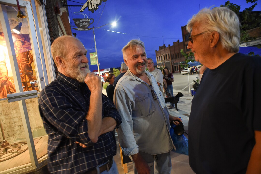 (Francisco Kjolseth  |  The Salt Lake Tribune)  Helper's community of artists, including painter David Richey Johnsen, actor Morgan Lund and Roy Jespersen, an expert in nonprofits, from left, join the festivities along Main Street for Helper First Fridays on Friday, Aug. 2, 2019. The community has been discovered by a variety of artists and dreamers seeking to escape the hustle of the Wasatch Front.