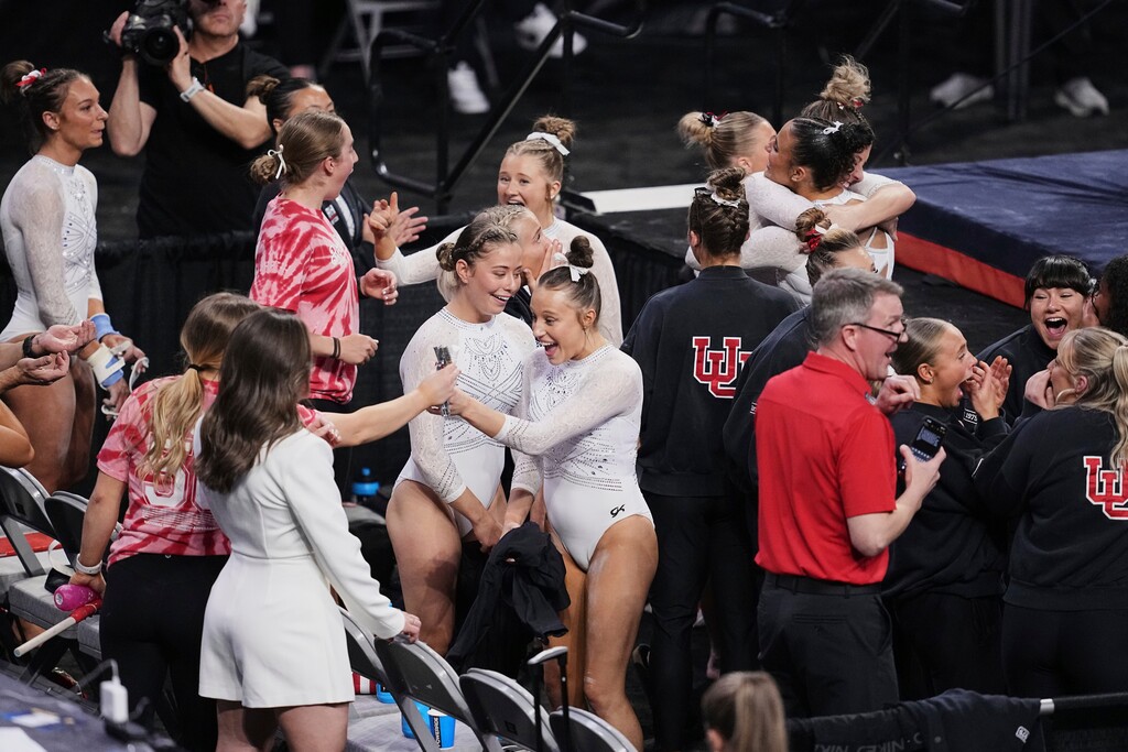 (Tony Gutierrez) | AP) Utah team and staff celebrate after learning the team's score in the semifinal of the NCAA women's gymnastics championships in Fort Worth, Texas, Thursday, April 17, 2025.