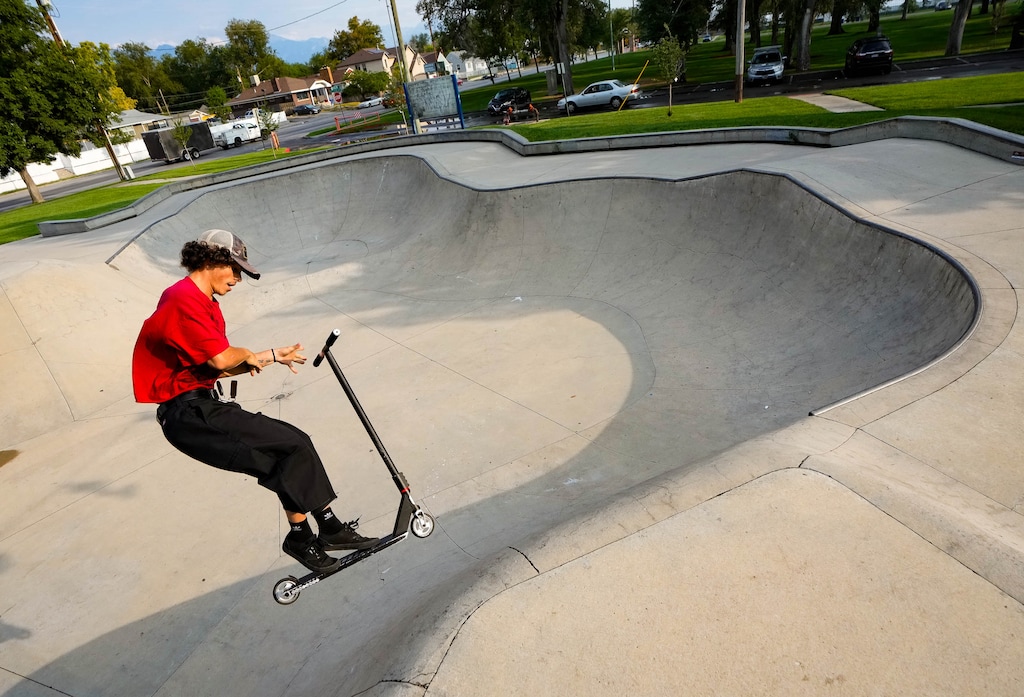 (Francisco Kjolseth | The Salt Lake Tribune) Tanner Jenkins practices his bar spin as he rides his scooter at Jordan Park on Wednesday, Aug. 27, 2025. The Salt Lake City Council recently approved funding to study and redesign the skatepark, with an eye toward expanding it in the future.