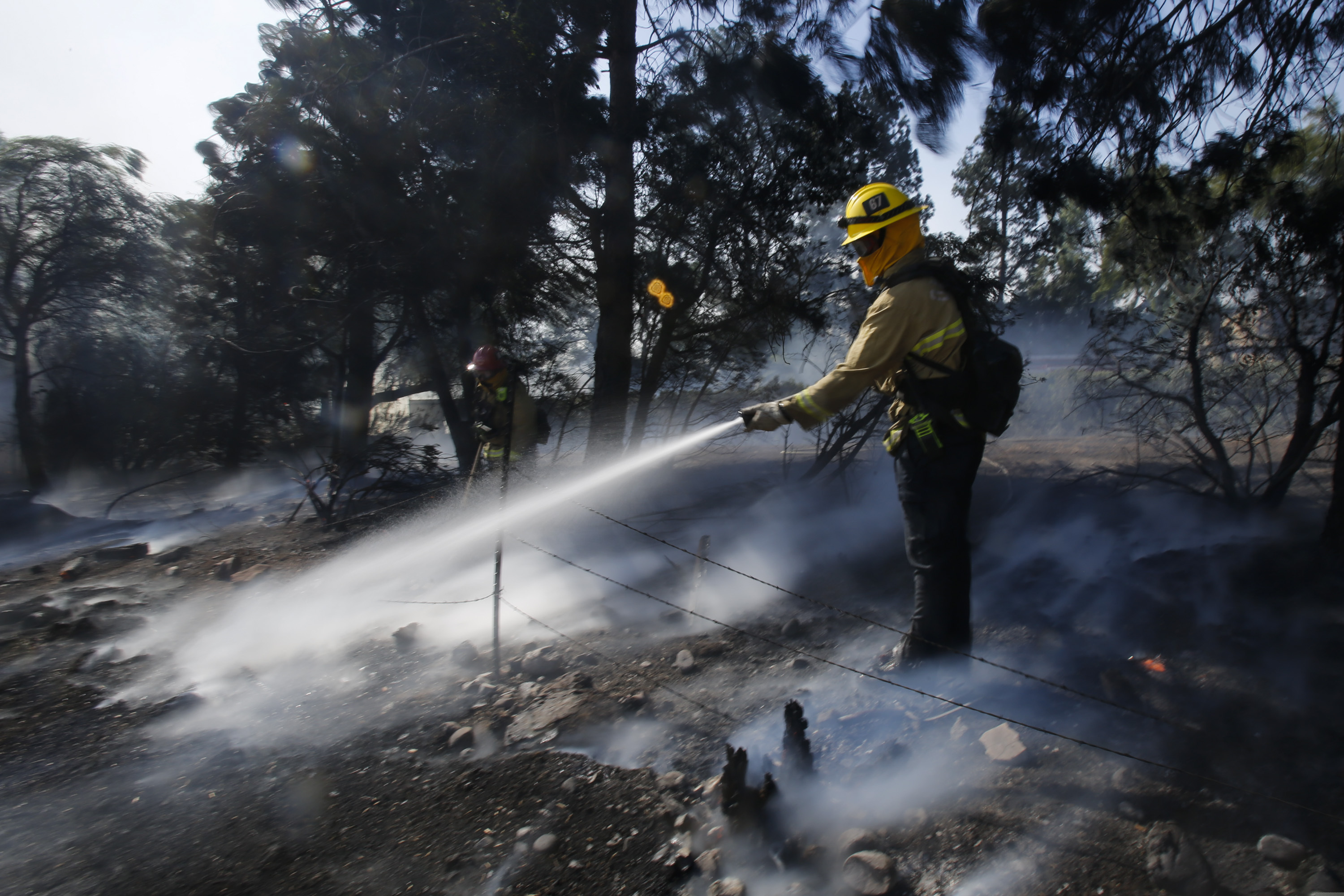 (Ringo H.W. Chiu | AP) Firefighters battle a wildfire near a ranch in Simi Valley, Calif., Wednesday, Oct. 30, 2019.