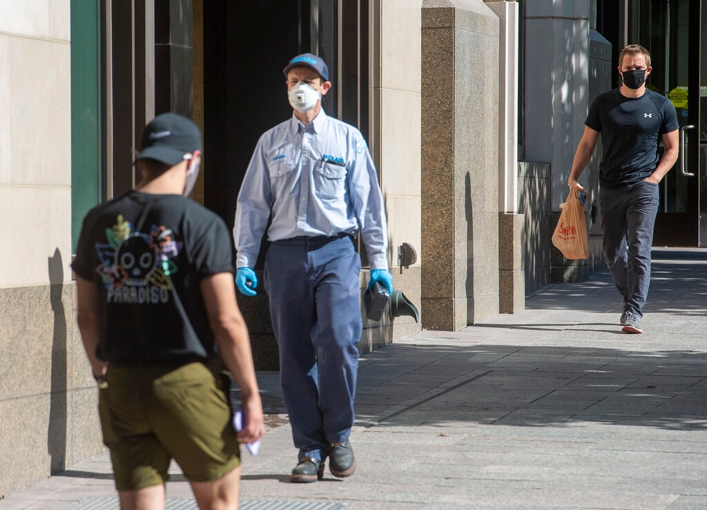 (Rick Egan  |  The Salt Lake Tribune)  Pedestrians wear masks as they walk on Main Street in Salt Lake City, on Thursday, July 9, 2020.